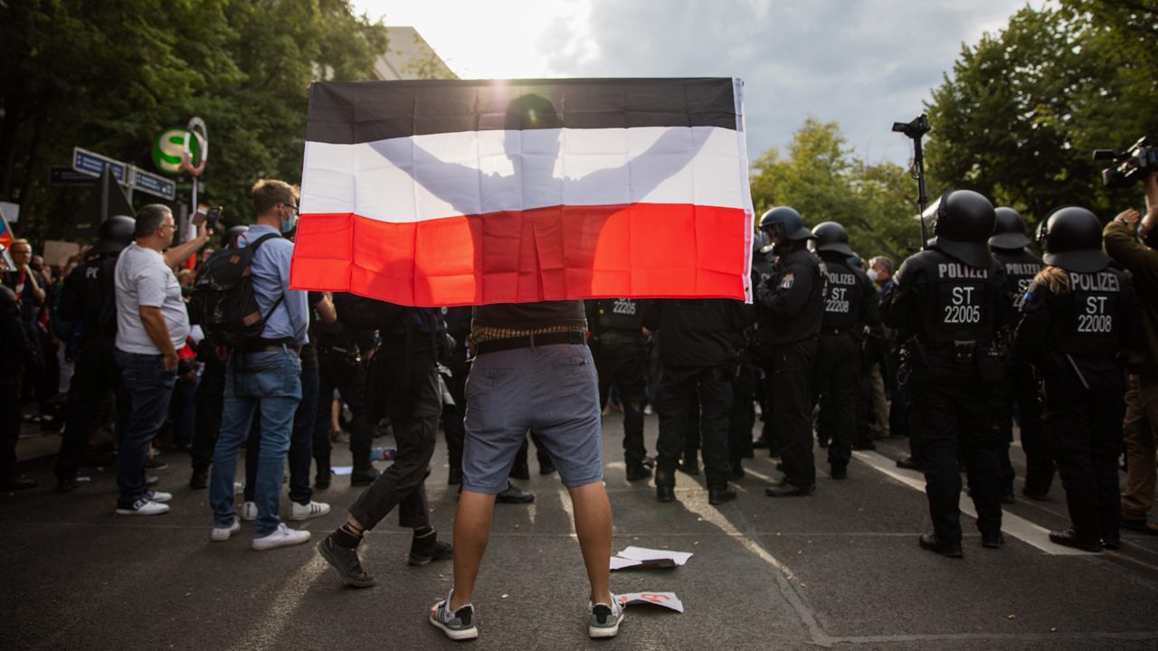 A man sporting a Reich flag at a demonstration against the German government's health measures against the coronavirus in Berlin.