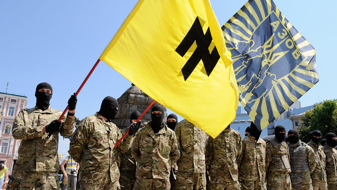 „Asow“-Soldaten in Kiew. Auf ihrer Flagge: eine Wolfsangel, beliebt unter Rechtsextremen und einst das Logo der NSDAP sowie von zahlreichen SS-Divisionen